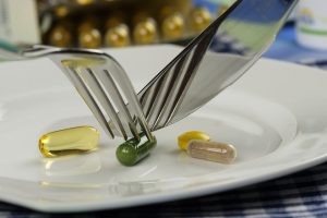 pills with fork and spoon